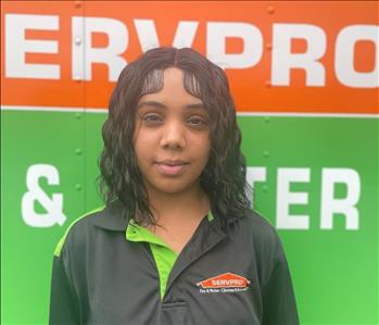 SERVPRO employee in front of SERVPRO background